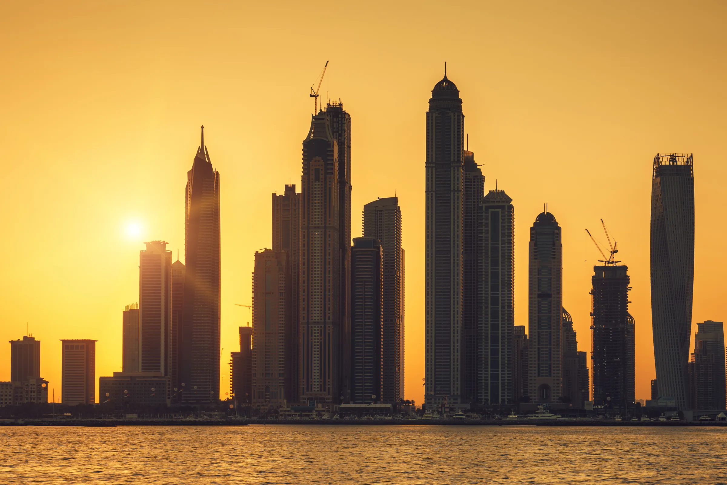 The towers of Dubai Marina against the setting sun